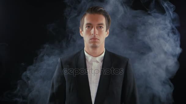 Portrait of young businessman in a smoke in a dark room — Stock Video