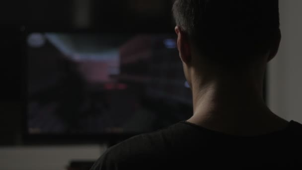 Gamer Plays A Video Game On A Computer In A Dark Room