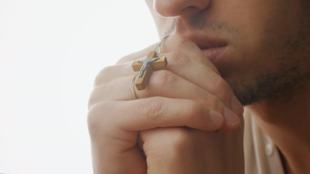 Close up of Young man praying to God. Concept of faith and religion — Stock Video