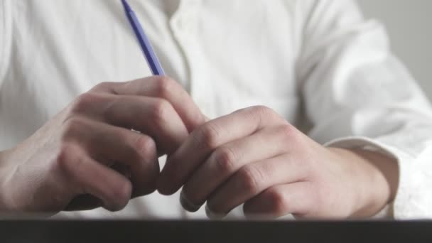 Крупним планом руки втомленого бізнесмена чекають чогось і роблять нервові рухи ручкою — стокове відео