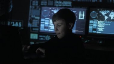 Sevimli genç çocuk programcı bir bilgisayarda veri merkezinde çalışan göstermek perde ile dolu. Harika çocuk hacker portresi.