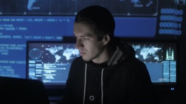 Genç Geek Hacker yazılımcı göstermek perde ile dolu siber güvenlik Merkezi'ndeki bilgisayarda çalışan.