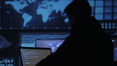 portre ile dolu veri merkezindeki bir bilgisayarda çalışan genç bir programcı görüntüleme ekranları