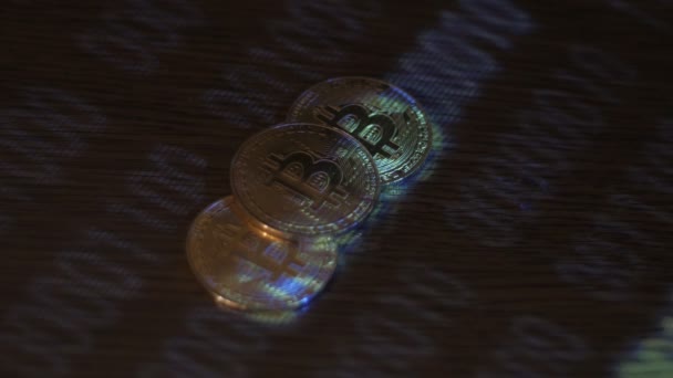 Reflection of binary code on bitcoin coins. Mining of crypto-currencies. Mining farm on earnings of crypto currency Bitcoin. — Stock Video