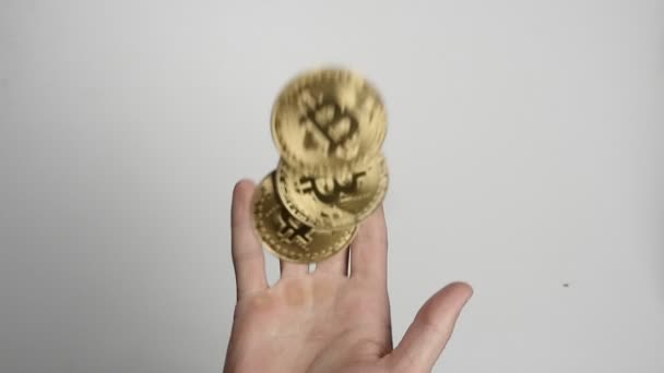 Close up mans hand throw up coins of bitcoin BTC in slow motion on isolated white background — Stock Video