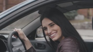 Arabada otururken gülüyor neşeli genç kadın portresi