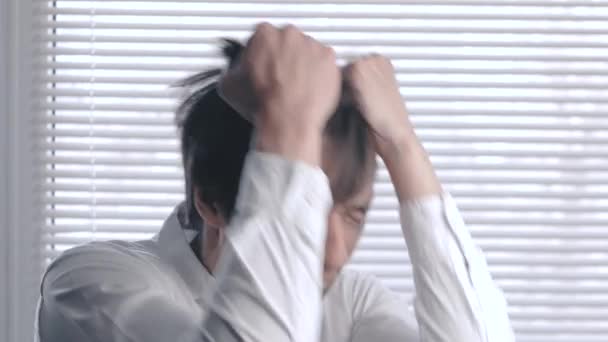 Young man in hysterics and desperation tearing his hair. young businessman who lost his business. man tears his hair — Stock Video