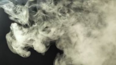 Duman, çerçevenin içinden siyah bir arka planda uçar. Efektler ve geçişler için iyi görüntüler.