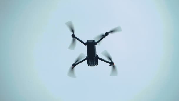Безпілотник літає в небі повільний рух, вид знизу — стокове відео