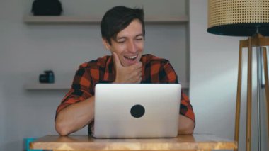 Overjoyed Excited Young Man Freelancer Looking At Laptop Celebrating Success Victory working at home