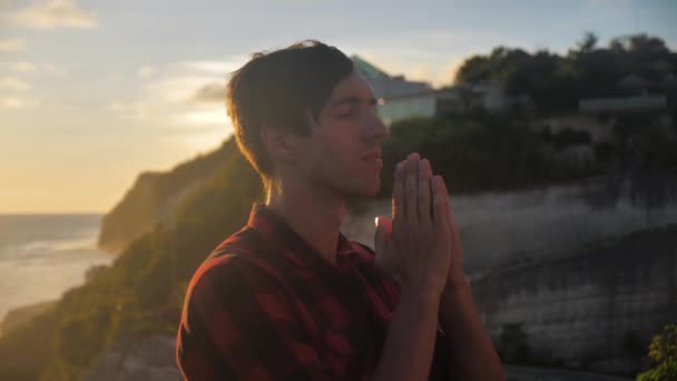 Silhouette eines Mannes, der bei Sonnenuntergang das Konzept der Religion betet. Silhouette Mann nah. — Stockvideo