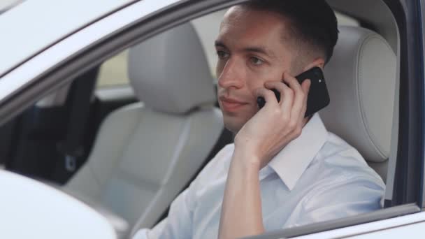 Young Businessman Talking On Mobile Phone In A Car — Stock Video