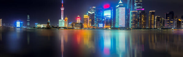City skyline lit up at night, Shanghai, China
