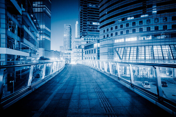 Footbridge with cityscape at night in Shanghai,China.
