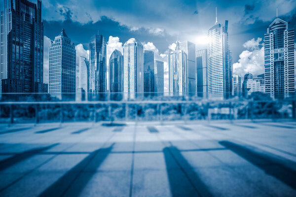 empty brick floor with modern building in background.