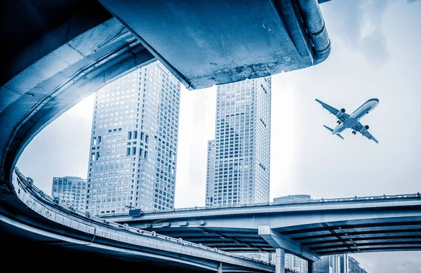 Blurred street scene in city with a plane flying over in city of China. — Stock Photo, Image