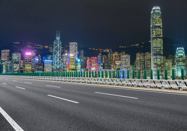 Empty highway and Hong Kong victoria skyline at night,china.