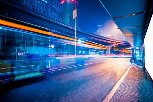 blurred traffic light trails on road at night