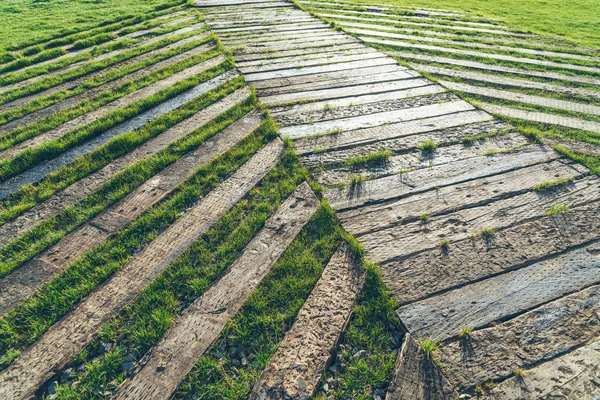 Full frame shot of wood walkway on grass — Stok Foto