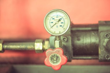 Pressure gauge on metal pipes at industry