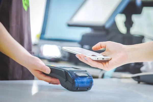 Close up of mobile payment in a shop — Stock Photo, Image