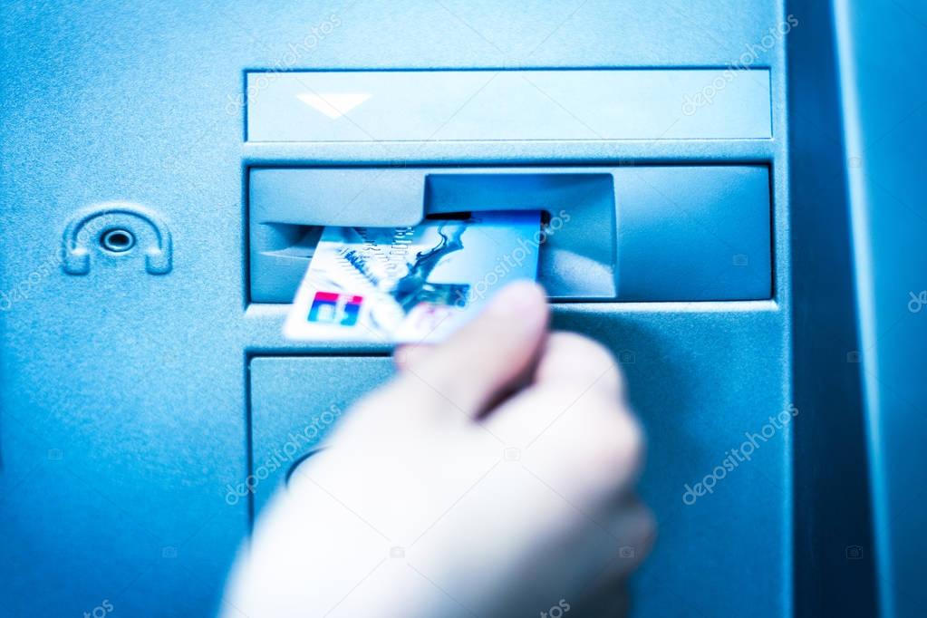 Woman using cash machine-ATM,close up view