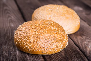 Ahşap masa arkasında pişmiş ekmek çeşitleri