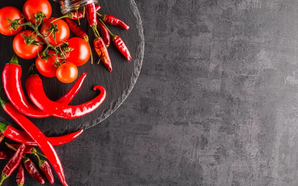 Vegetables. Peppers, tomatoes, garlic, onions on a black backgro — Stock Photo, Image