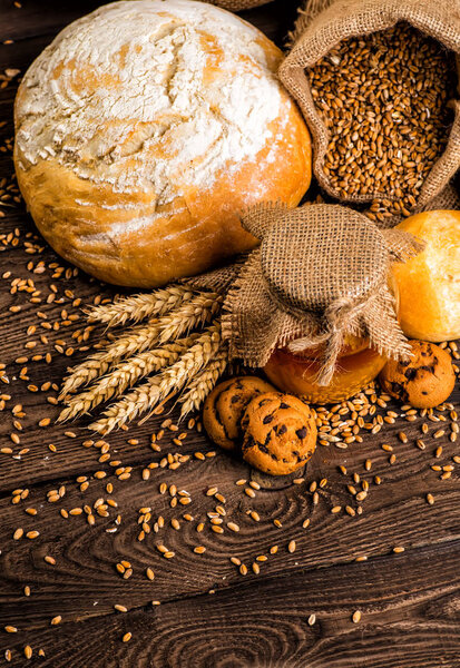 Freshly baked traditional bread with honey on a wooden table