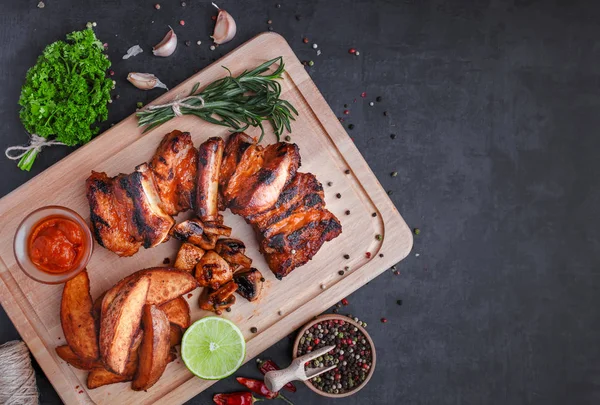 Grilled meat and vegetables on rustic wooden table