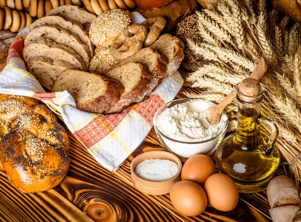 Асортимент запеченого хліба на дерев'яному фоні столу — стокове фото