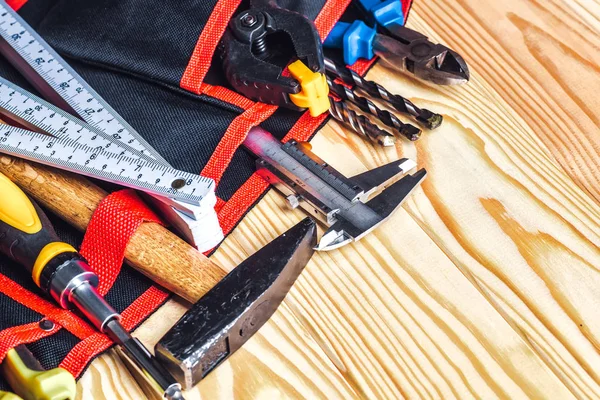 tools in tool belt on wood planks with copy space