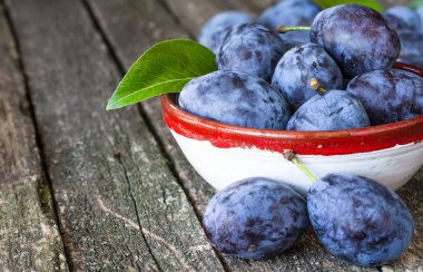 Ahşap masa arka plan üzerinde taze Erik. Mavi Erik meyve yarısı.