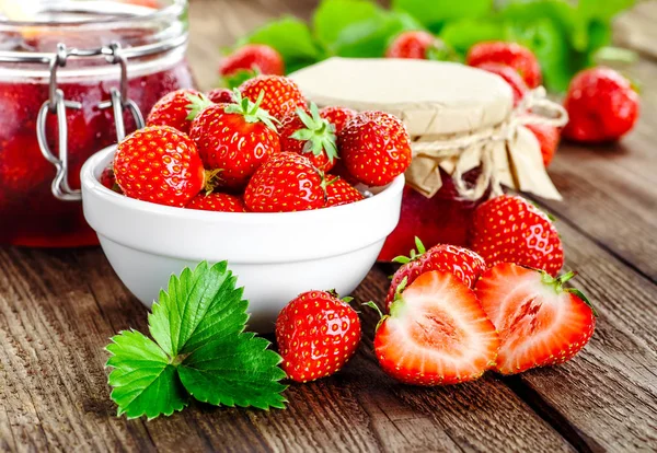 Zelfgemaakte aardbeienjam of marmelade in de glazen pot en de ba — Stockfoto