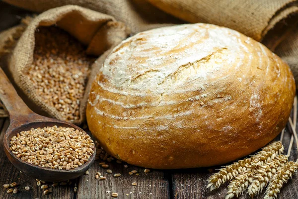 loaf of bread on wooden background, food closeup.Fresh homemade