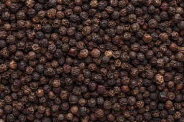 Biber arkaplanı. Kuru karabiber çekirdeği. Üst Manzara. Düz dizayn. Makro baharat arkaplanı