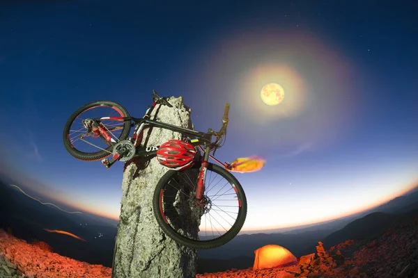 Ποδήλατο σε μια πέτρινη κολόνα κορυφές τη νύχτα — Φωτογραφία Αρχείου
