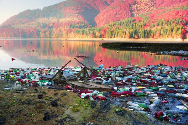 Wooden boat in plastic debris