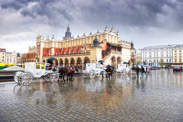 Old carriages in modern Krakow — Stock Photo, Image