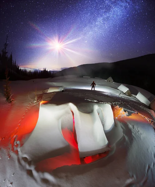 観光客のための避難所であり 火の途中でウクライナの Goverla の高山で冬にハンターが屋根に 雪崩のような雪で覆われている山小屋 — ストック写真