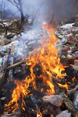 Tourist photographed a panorama of ecological disaster - the river carries plastic rubbish to Europe, abandoned by non-cultural populations. plastic fire releases dangerous chemicals clipart