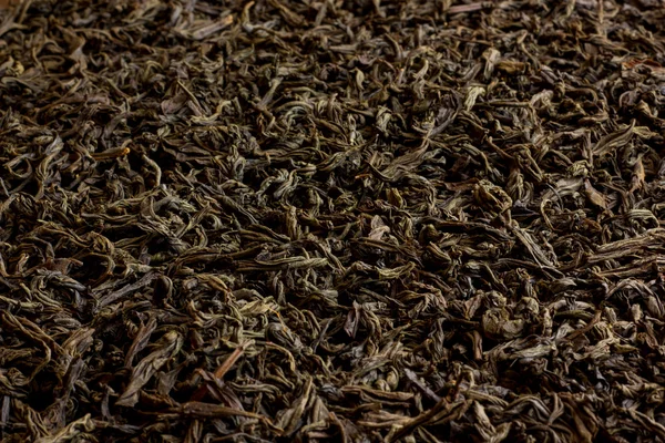 Textur des schwarzen Tees, Hintergrund — Stockfoto