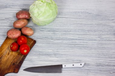 Bıçak Beyaz ahşap arka plan Üstten Görünüm noktası ile çeşitli taze sebze.
