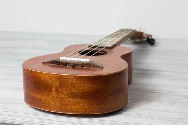 Primo piano di ukulele su sfondo vecchio di legno — Foto Stock