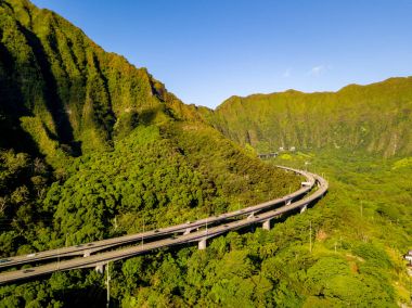 Gorgeous aerial view of the Oahu green mountains view by the Ho'omaluhia Botanical Garden in Kaneohe. Mountains with famous stairs to heaven or Haiku stairs. clipart