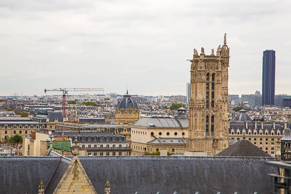 Aerial street view of Paris from above with a Notre Dame tower heading above the city.