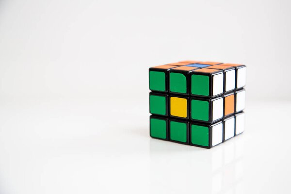 Rubik's cube on the white or wooden background