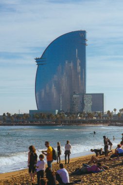 Ufuk ve kumun üzerinde yalan insanlara şaşırtıcı W otel manzaralı Barcelona meşgul beach.