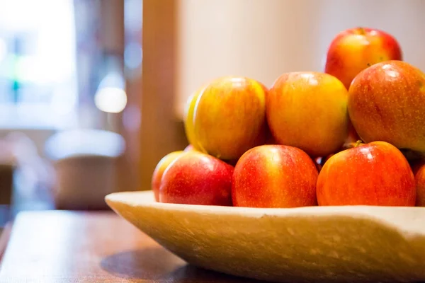 Red tasty apples sorted out on a plate on a table