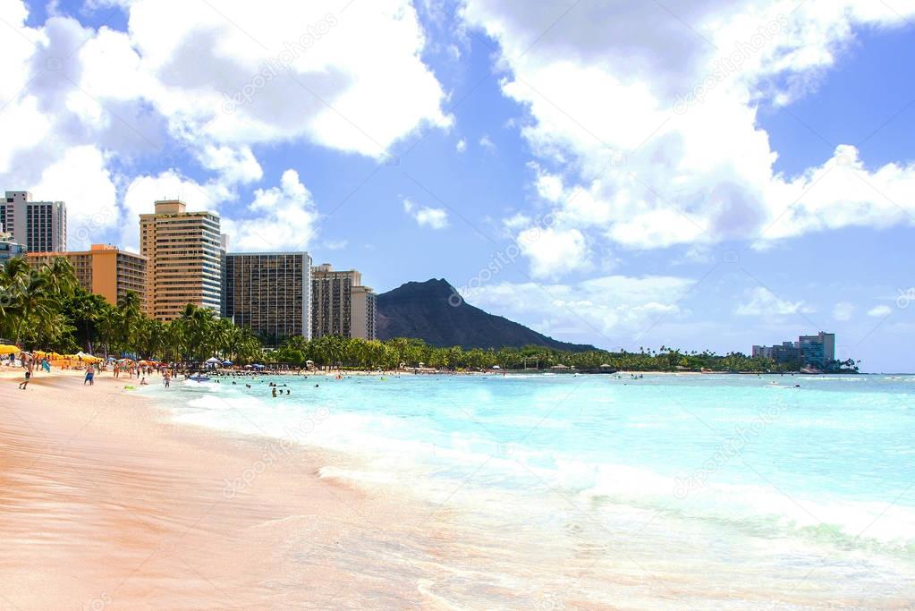 Gorgeous beach view with buildings and diamond head cliff on the island of Oahu, Hawaii.